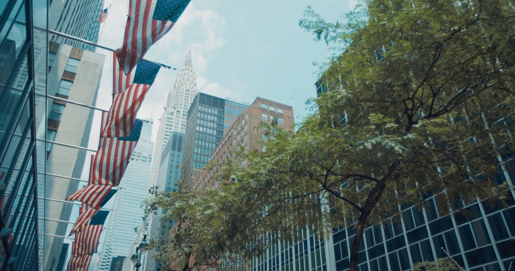 Urban skyline with American flags, highlighting economic strength