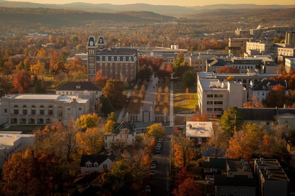 Aerial view of Fayetteville, Arkansas in autumn, showcasing historic university buildings and scenic fall colors
