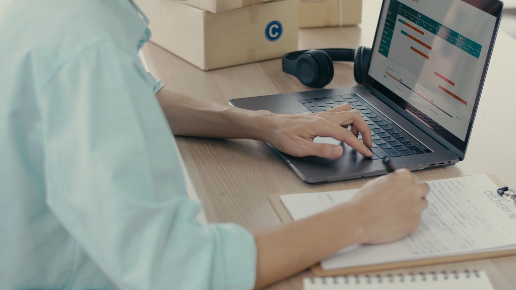 Online seller reviewing startup budget and business costs on a laptop
